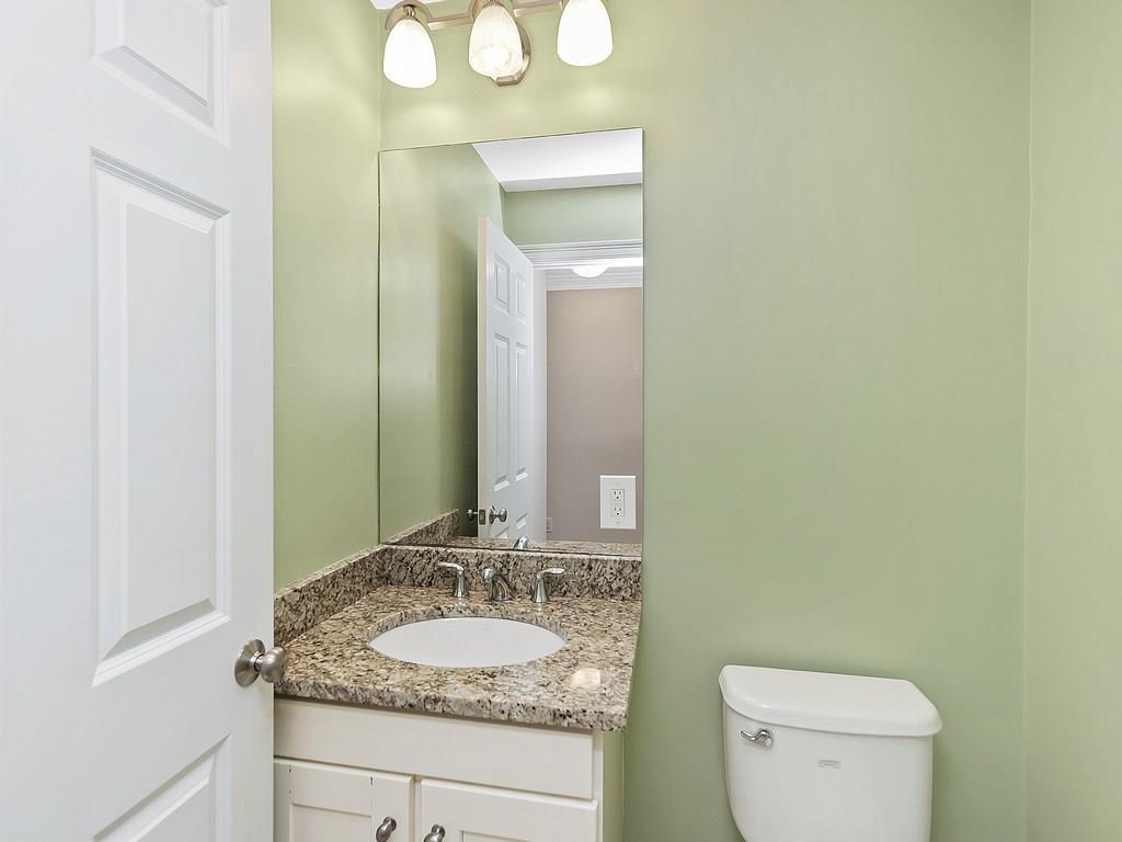 179 Florence Road Waltham, MA 02453 - Photo 17 of 37 a bathroom with a granite countertop sink and a mirror with toilet