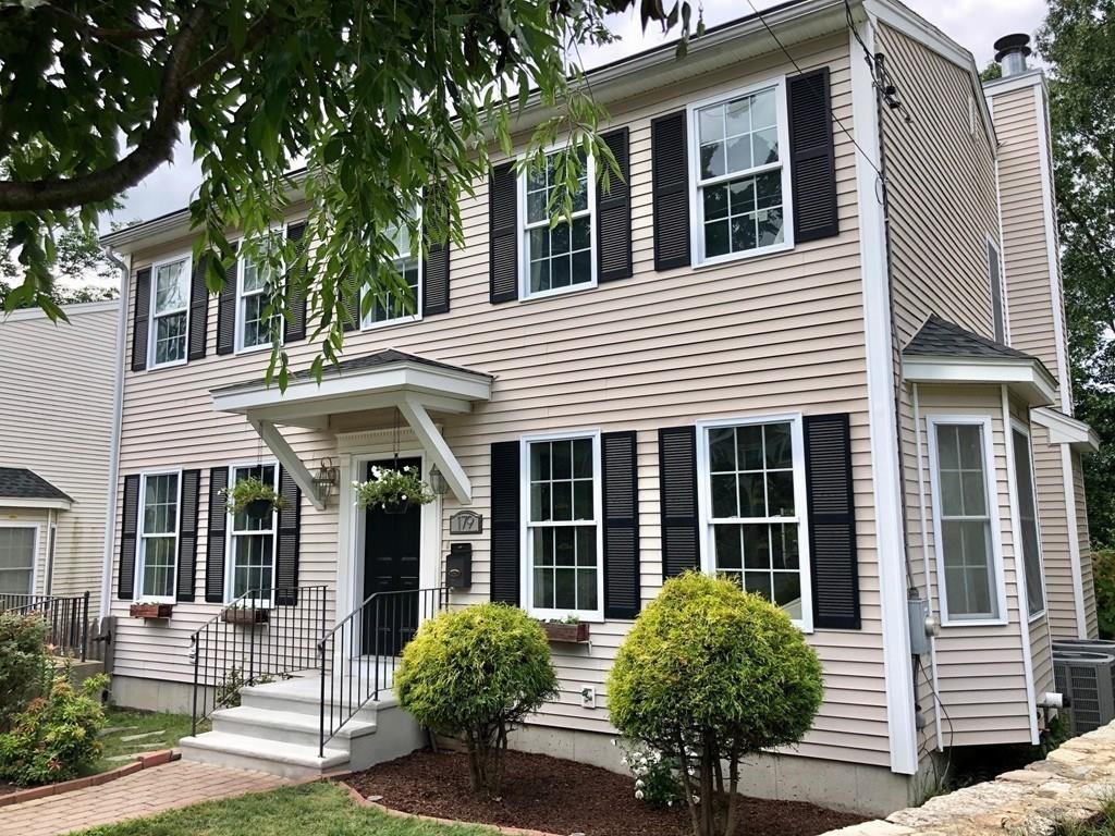 179 Florence Road Waltham, MA 02453 - Photo 2 of 37 a house with potted plants in front of it