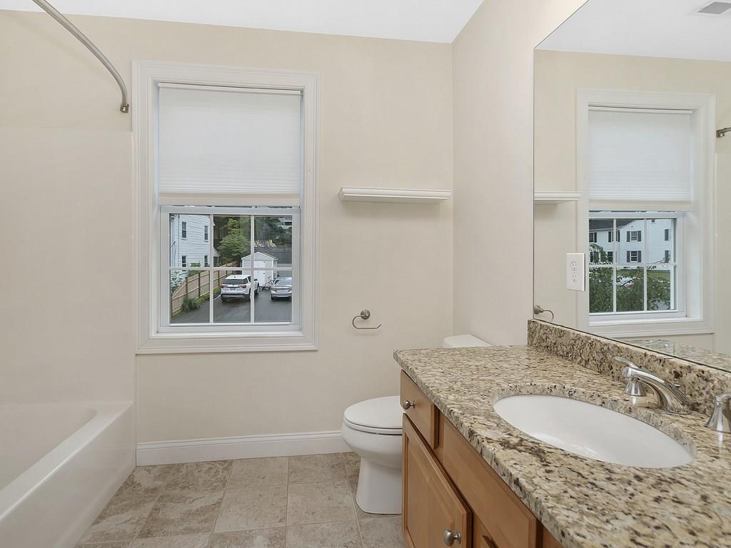179 Florence Road Waltham, MA 02453 - Photo 22 of 37 a bathroom with a granite countertop sink toilet and shower