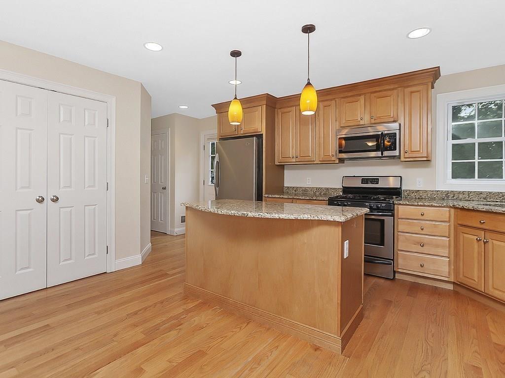179 Florence Road Waltham, MA 02453 - Photo 5 of 37 a kitchen with stainless steel appliances granite countertop a stove a sink and a refrigerator