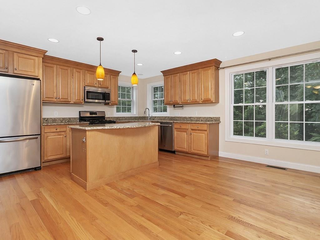 179 Florence Road Waltham, MA 02453 - Photo 6 of 37 a kitchen with stainless steel appliances granite countertop a stove a sink dishwasher a refrigerator and a microwave