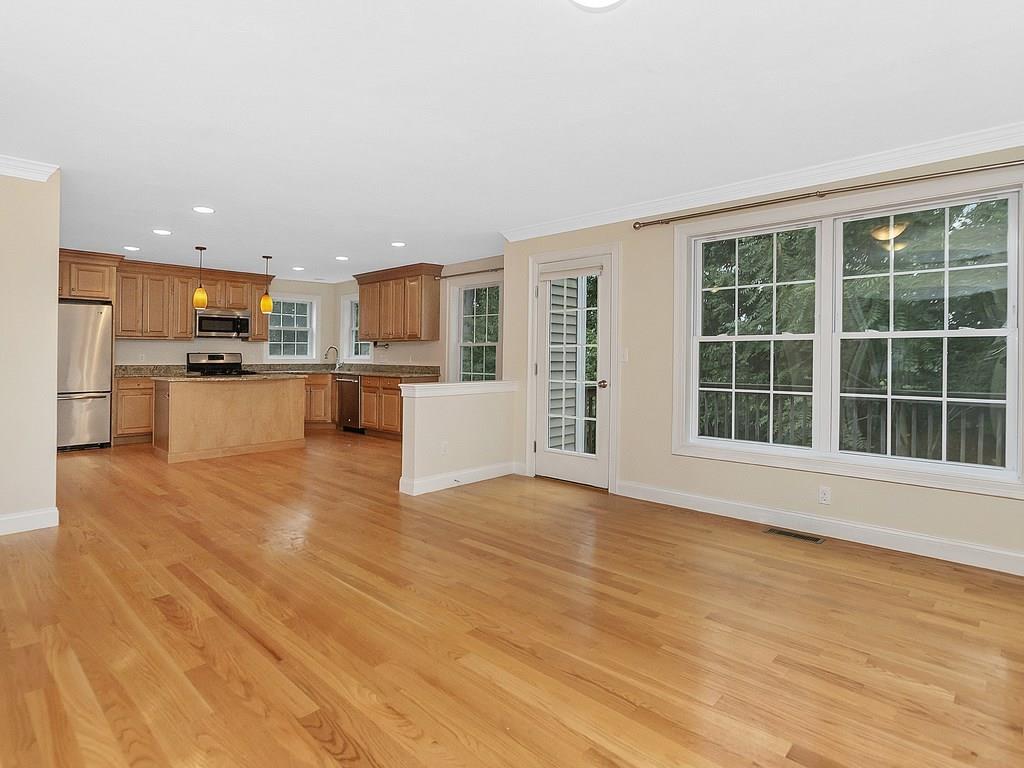 179 Florence Road Waltham, MA 02453 - Photo 9 of 37 a view of a living room with kitchen and wooden floor