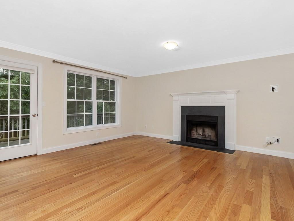 179 Florence Road Waltham, MA 02453 - Photo 10 of 37 an empty room with a fireplace and window