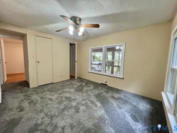a view of a livingroom with a ceiling fan and window
