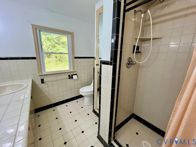 a bathroom with a sink a mirror and shower
