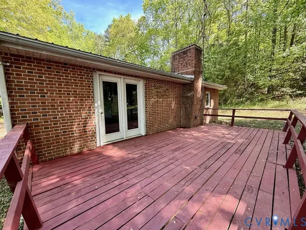 a view of a patio with table and chairs a barbeque with wooden floor and fence
