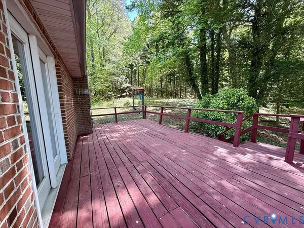 a view of backyard of house with wooden fence