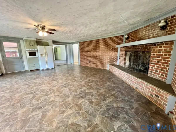 wooden floor in an empty room with a fireplace