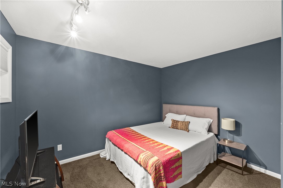 1964 Columbus Road Cleveland, OH 44113 - Photo 27 of 33 Carpeted bedroom featuring rail lighting