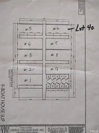 a sign board with tree in the background