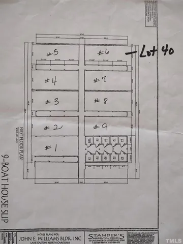 a sign board with tree in the background