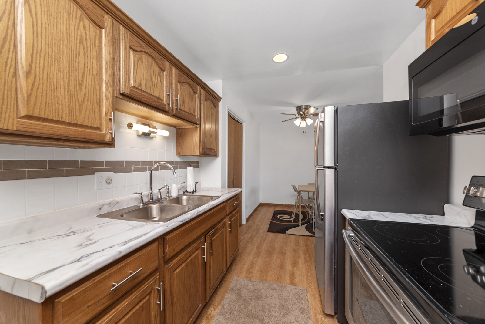 903 Elder Road, Unit 6 Homewood, IL 60430 - Photo 2 of 12 a kitchen with granite countertop stainless steel appliances and sink
