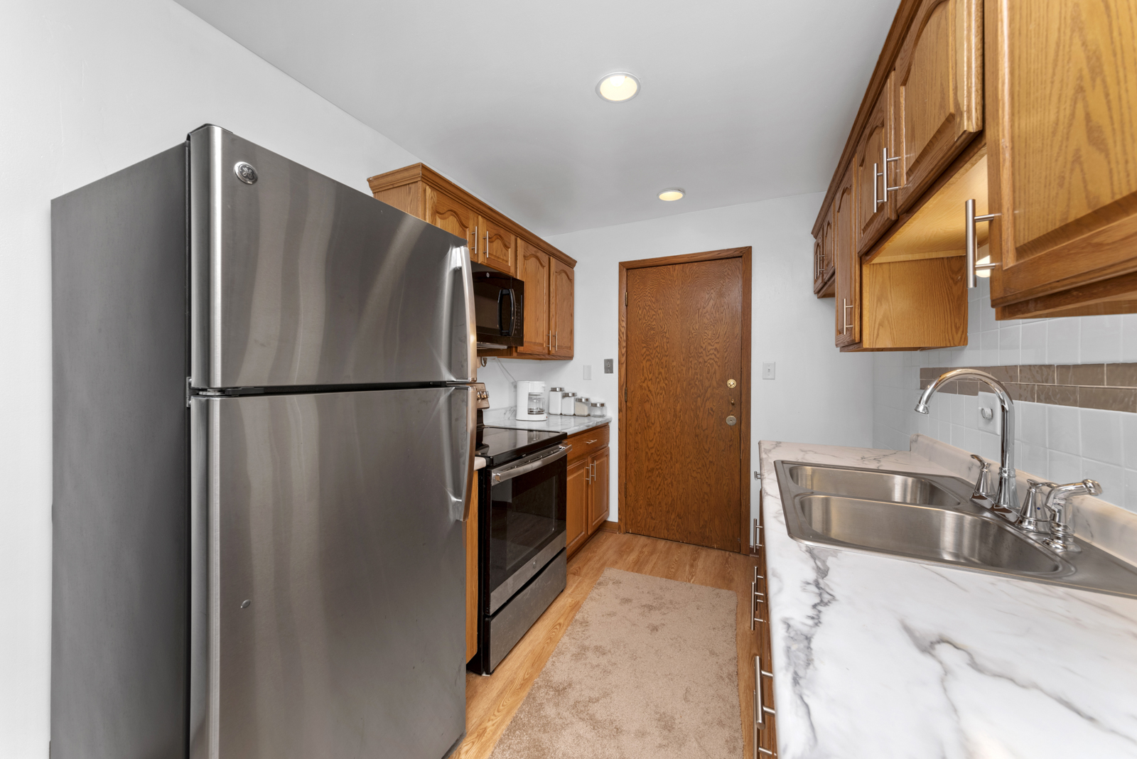 903 Elder Road, Unit 6 Homewood, IL 60430 - Photo 3 of 12 a kitchen with stainless steel appliances granite countertop a refrigerator and a sink