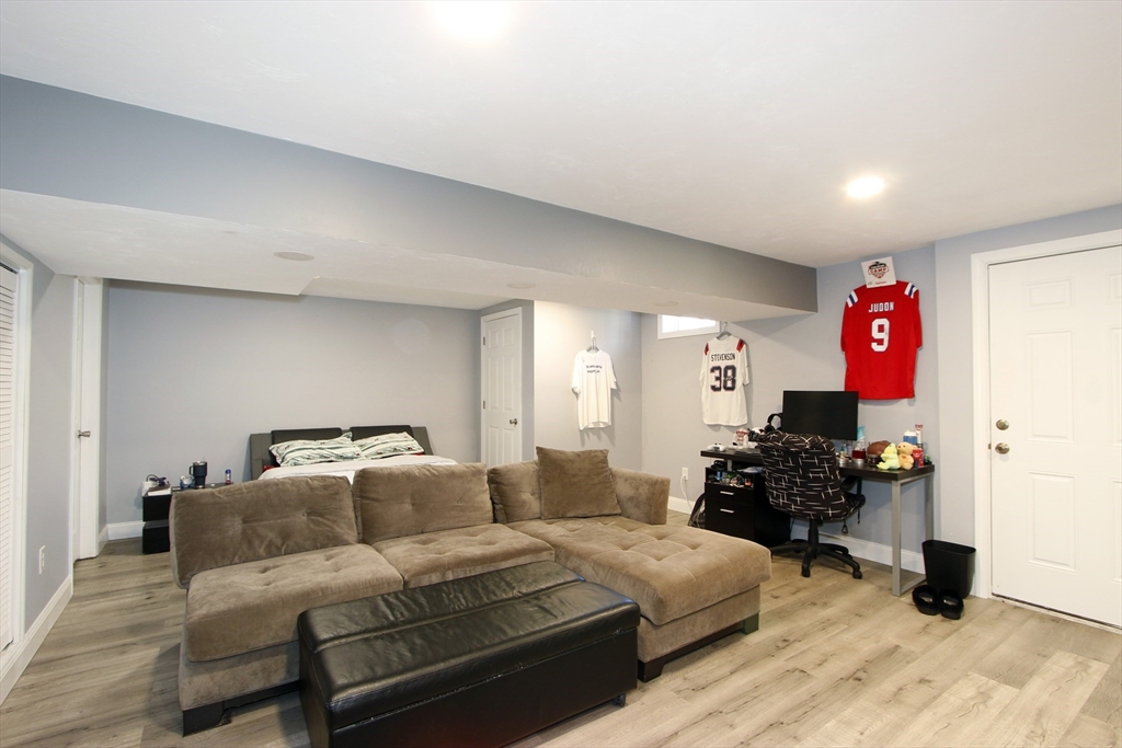 923 Walnut Plain Road Rochester, MA 02770 - Photo 36 of 38 a living room with furniture and a chandelier