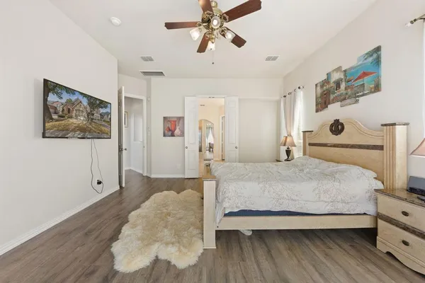 a bedroom with a bed and a painting on the wall