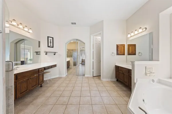 a spacious bathroom with a granite countertop sink mirror and toilet
