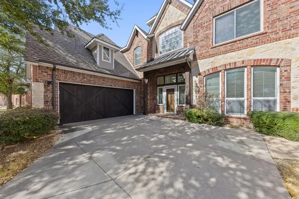a front view of a building with a yard and garage