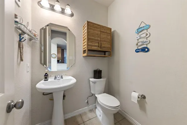 a bathroom with a sink mirror and toilet
