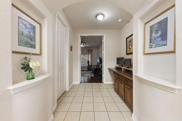 a hallway with a black white checkered floor and a large window