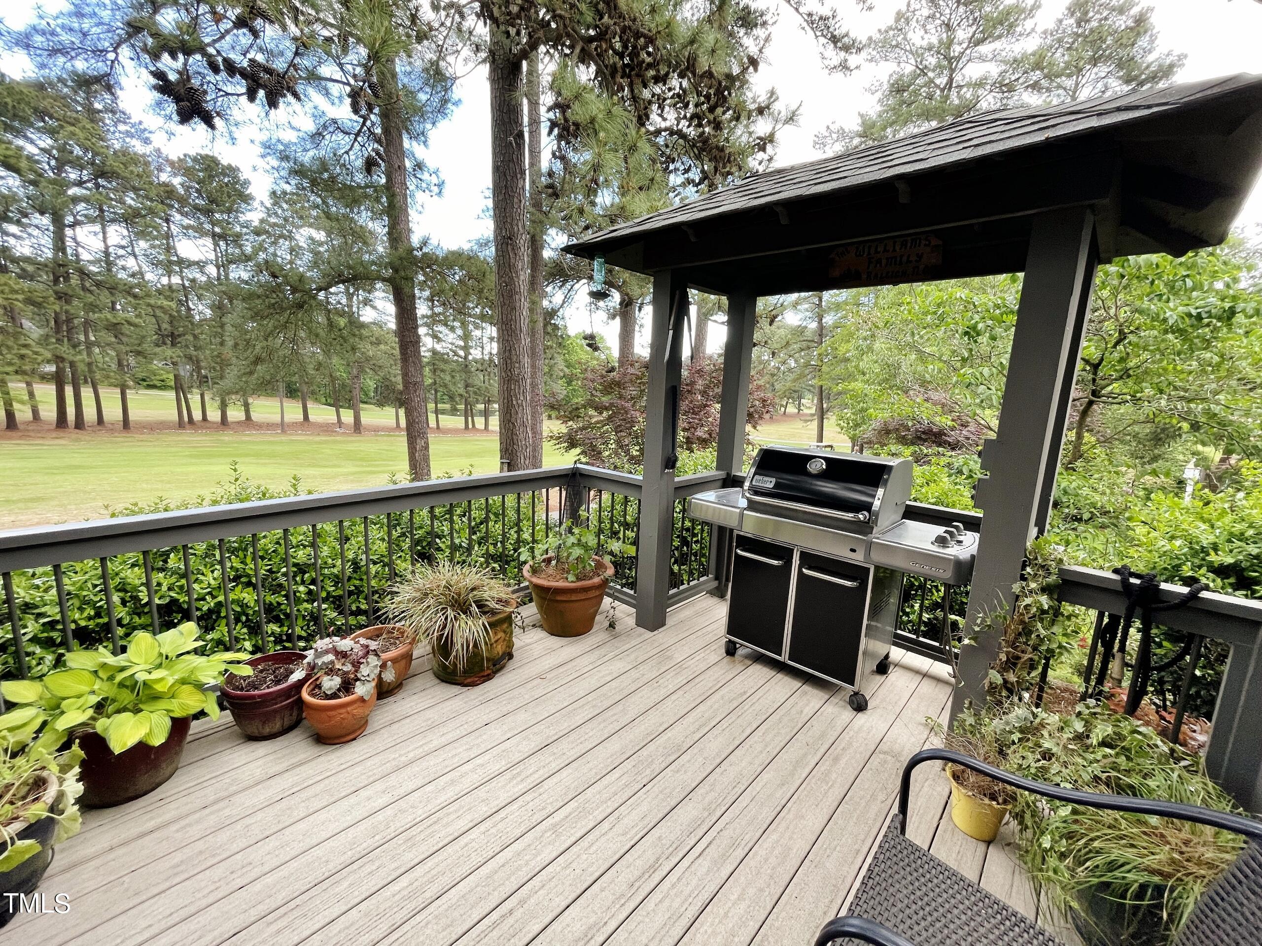 2924 Ballybunion Way Raleigh, NC 27613 - Photo 35 of 54 a view of a deck with wooden floor barbeque oven and chairs