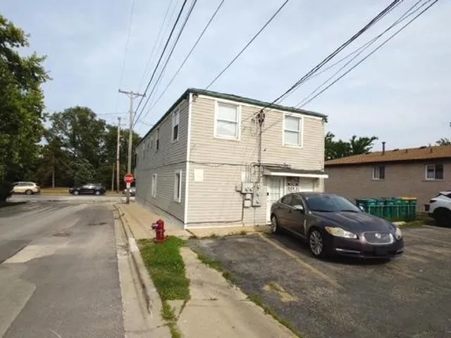 a view of a car parked in front of a house