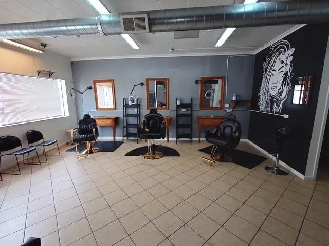 a view of a livingroom with workspace and a window