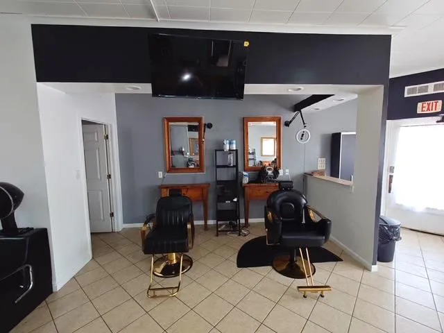 a living room with furniture and a gym machine