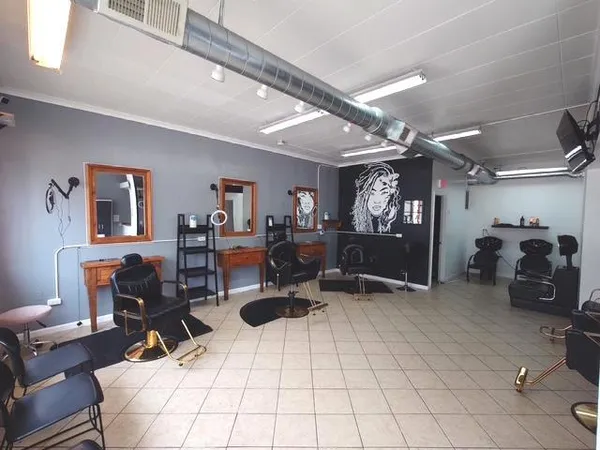 a living room with furniture gym equipment and view of gym equipment