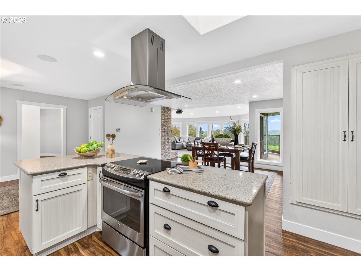 29009 Southwest Burkhalter Road Hillsboro, OR 97123 - Photo 11 of 48 a kitchen with stainless steel appliances a stove a sink cabinets and wooden floor