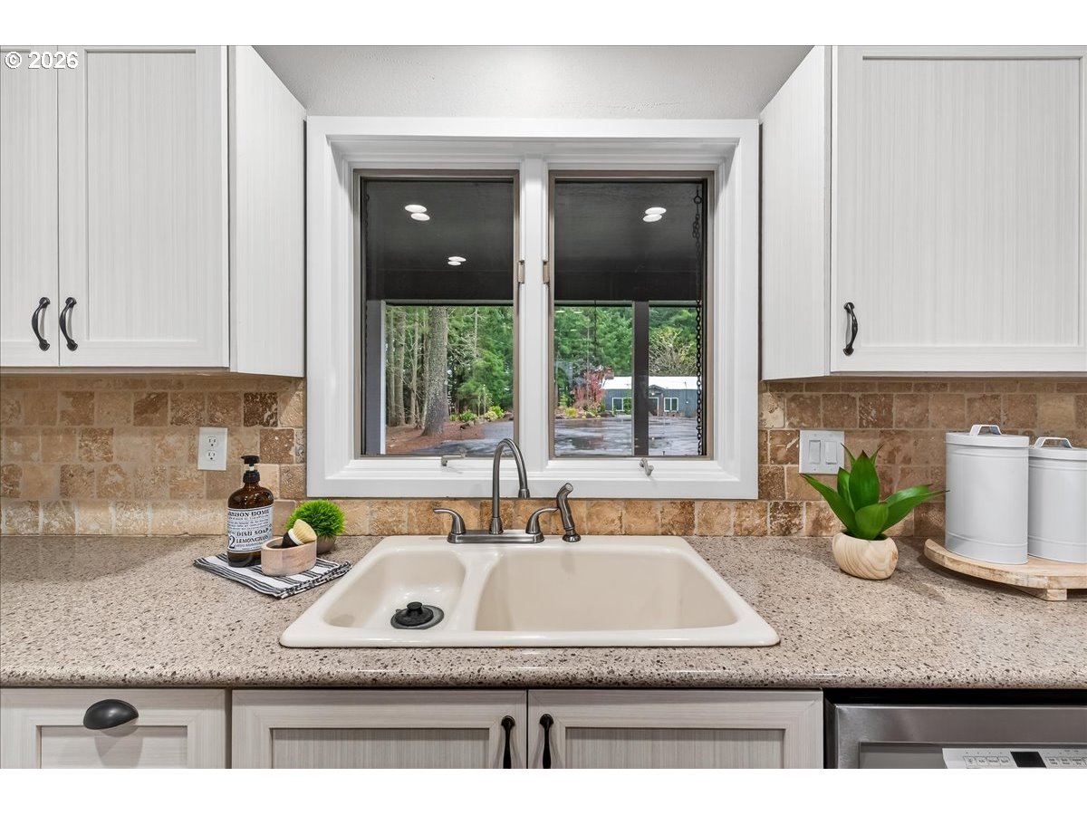 29009 Southwest Burkhalter Road Hillsboro, OR 97123 - Photo 12 of 48 a kitchen with granite countertop a sink a stove and a window