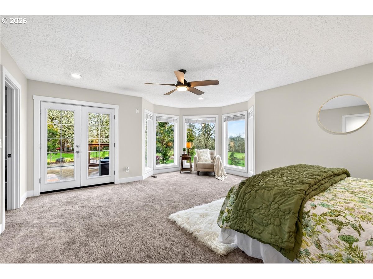 29009 Southwest Burkhalter Road Hillsboro, OR 97123 - Photo 15 of 48 a bed room with a bed and a large window