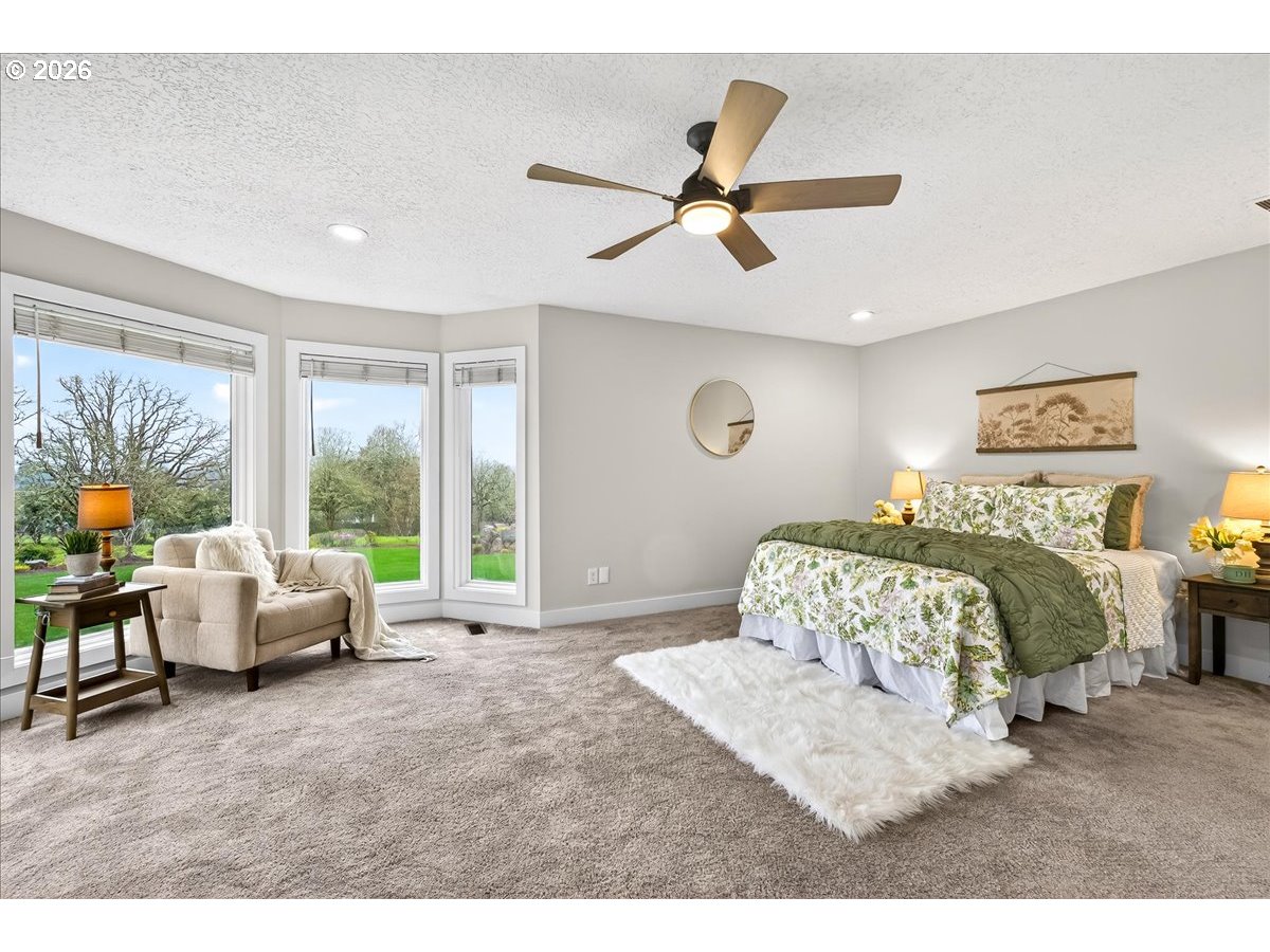 29009 Southwest Burkhalter Road Hillsboro, OR 97123 - Photo 16 of 48 a bedroom with a bed and a large window