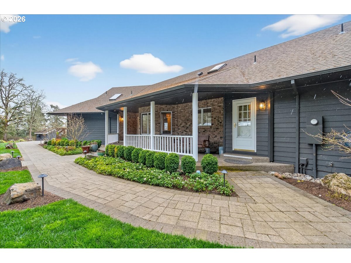 29009 Southwest Burkhalter Road Hillsboro, OR 97123 - Photo 2 of 48 a view of brick house with a yard and plants