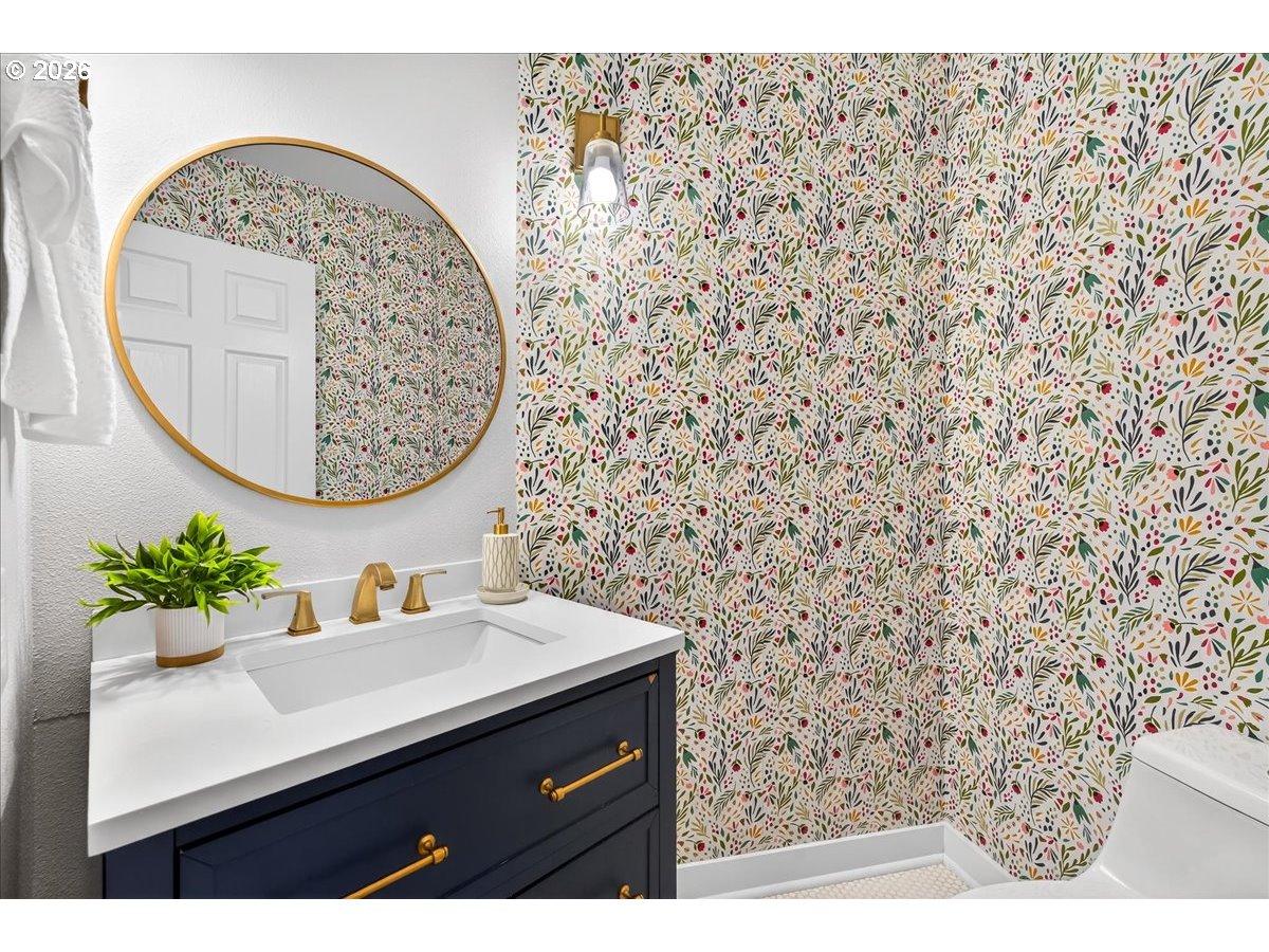 29009 Southwest Burkhalter Road Hillsboro, OR 97123 - Photo 21 of 48 a bathroom with a sink a mirror and a shower