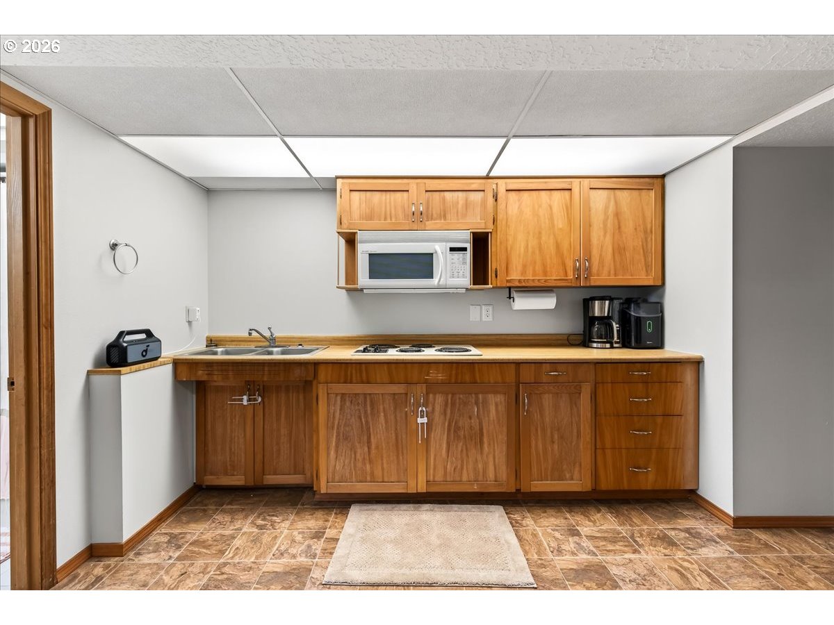 29009 Southwest Burkhalter Road Hillsboro, OR 97123 - Photo 24 of 48 a view of kitchen with granite countertop cabinets and window