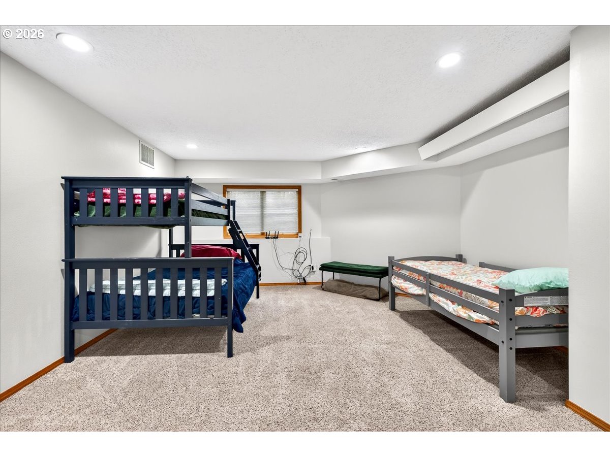 29009 Southwest Burkhalter Road Hillsboro, OR 97123 - Photo 25 of 48 a bedroom with furniture and a window