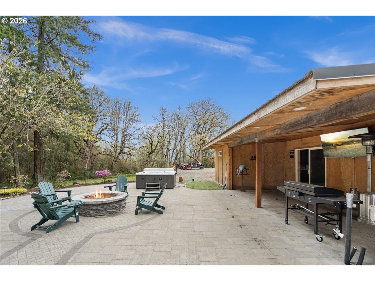 29009 Southwest Burkhalter Road Hillsboro, OR 97123 - Photo 29 of 48 a roof deck with table and chairs a barbeque and potted plants by side of it