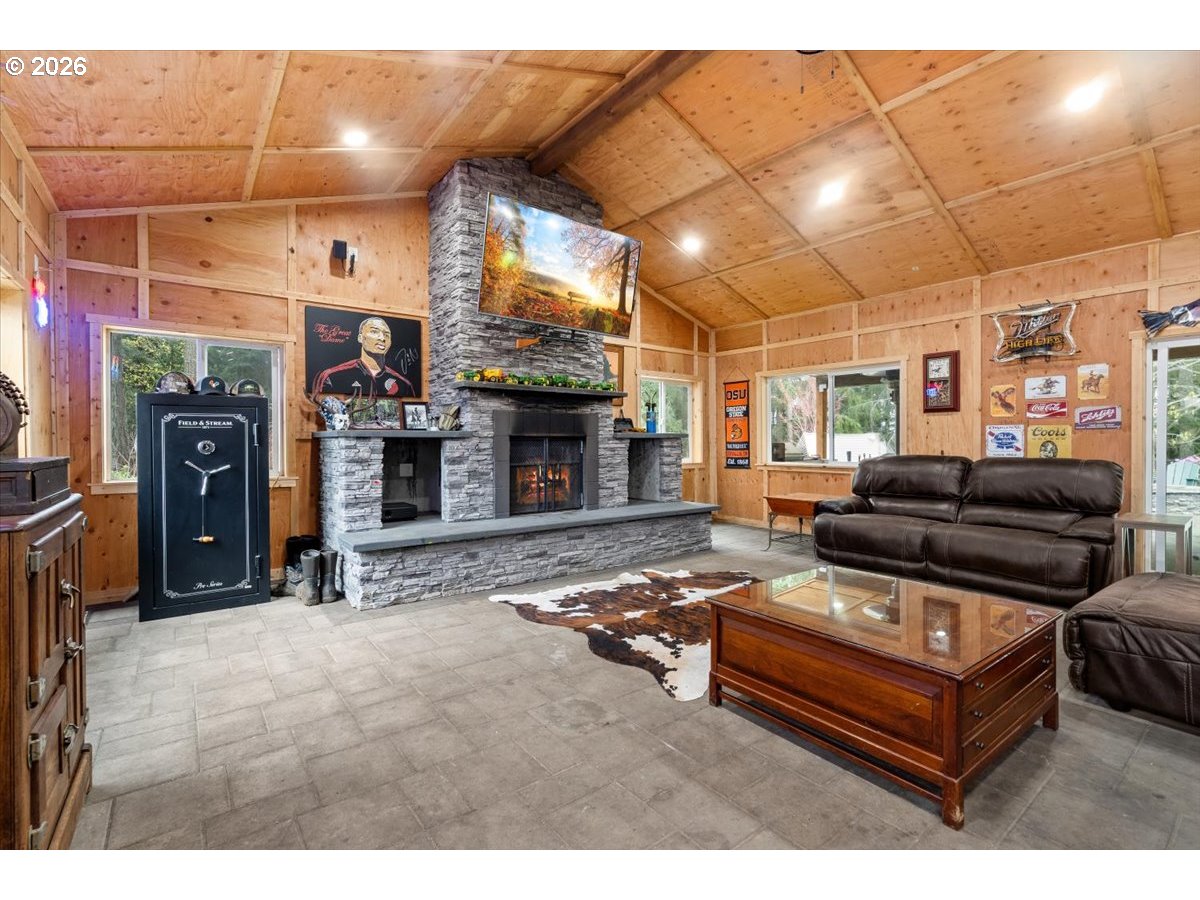 29009 Southwest Burkhalter Road Hillsboro, OR 97123 - Photo 33 of 48 a living room with furniture a flat screen tv and a fireplace