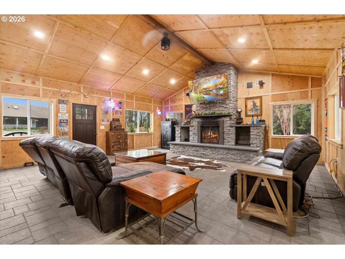 29009 Southwest Burkhalter Road Hillsboro, OR 97123 - Photo 34 of 48 a living room with furniture a fireplace and a table