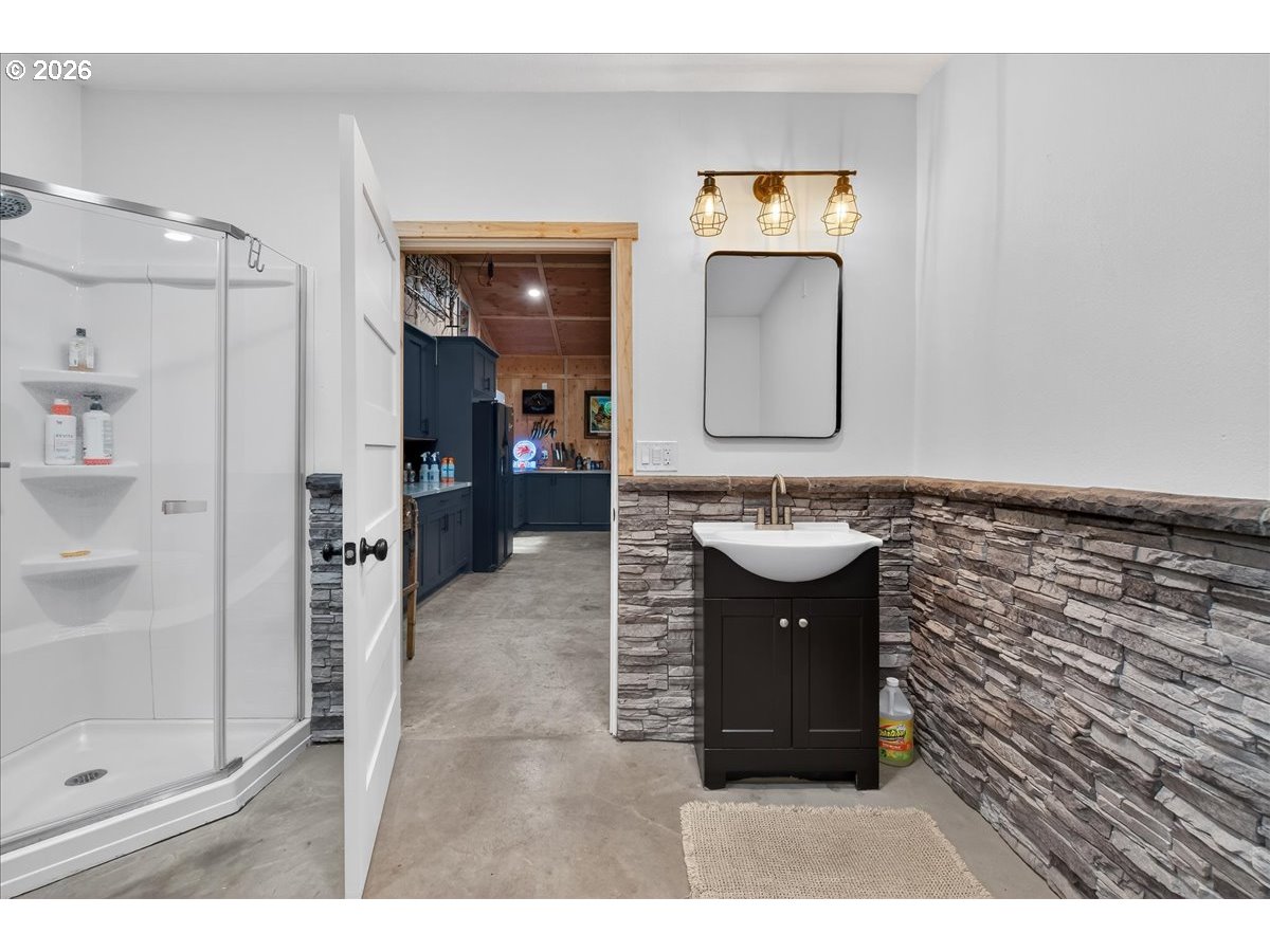 29009 Southwest Burkhalter Road Hillsboro, OR 97123 - Photo 36 of 48 a bathroom with a sink a mirror and a shower