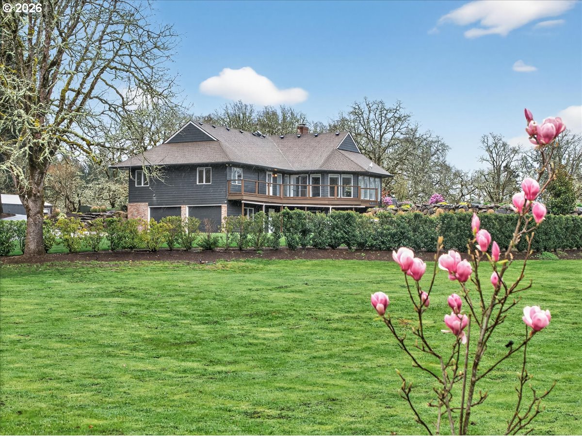 29009 Southwest Burkhalter Road Hillsboro, OR 97123 - Photo 41 of 48 a front view of a house with a big yard and potted plants