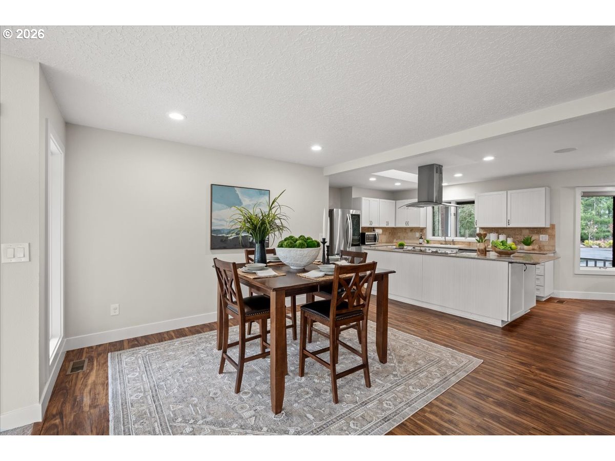 29009 Southwest Burkhalter Road Hillsboro, OR 97123 - Photo 8 of 48 a view of a dining room with furniture and wooden floor