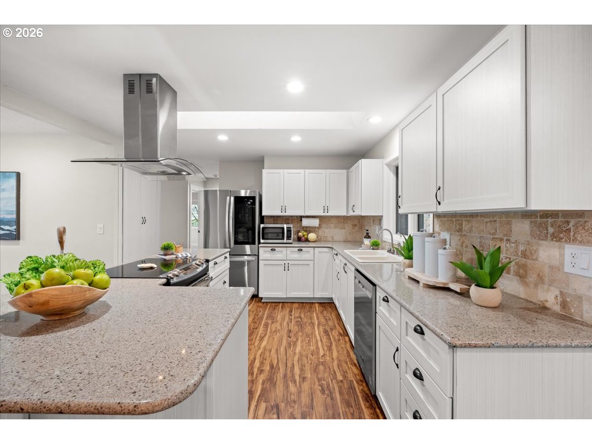 29009 Southwest Burkhalter Road Hillsboro, OR 97123 - Photo 10 of 48 a kitchen with sink refrigerator and microwave