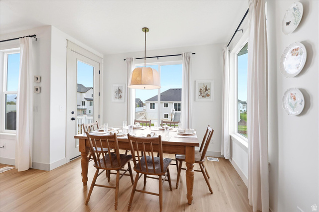 283 North 500 West Mapleton, UT 84664 - Photo 21 of 102 Dining room featuring light wood-style flooring, healthy amount of natural light and a luxury light.