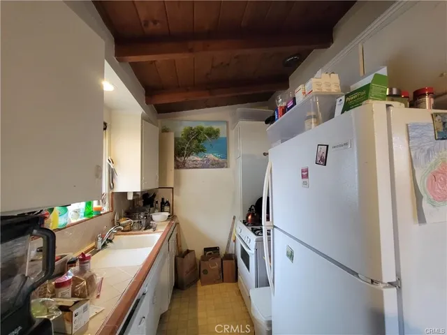 a refrigerator freezer sitting inside of a kitchen