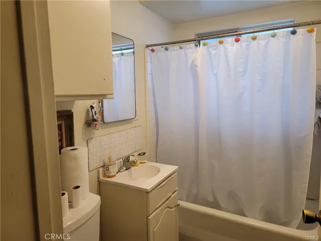 a bathroom with a sink toilet and mirror