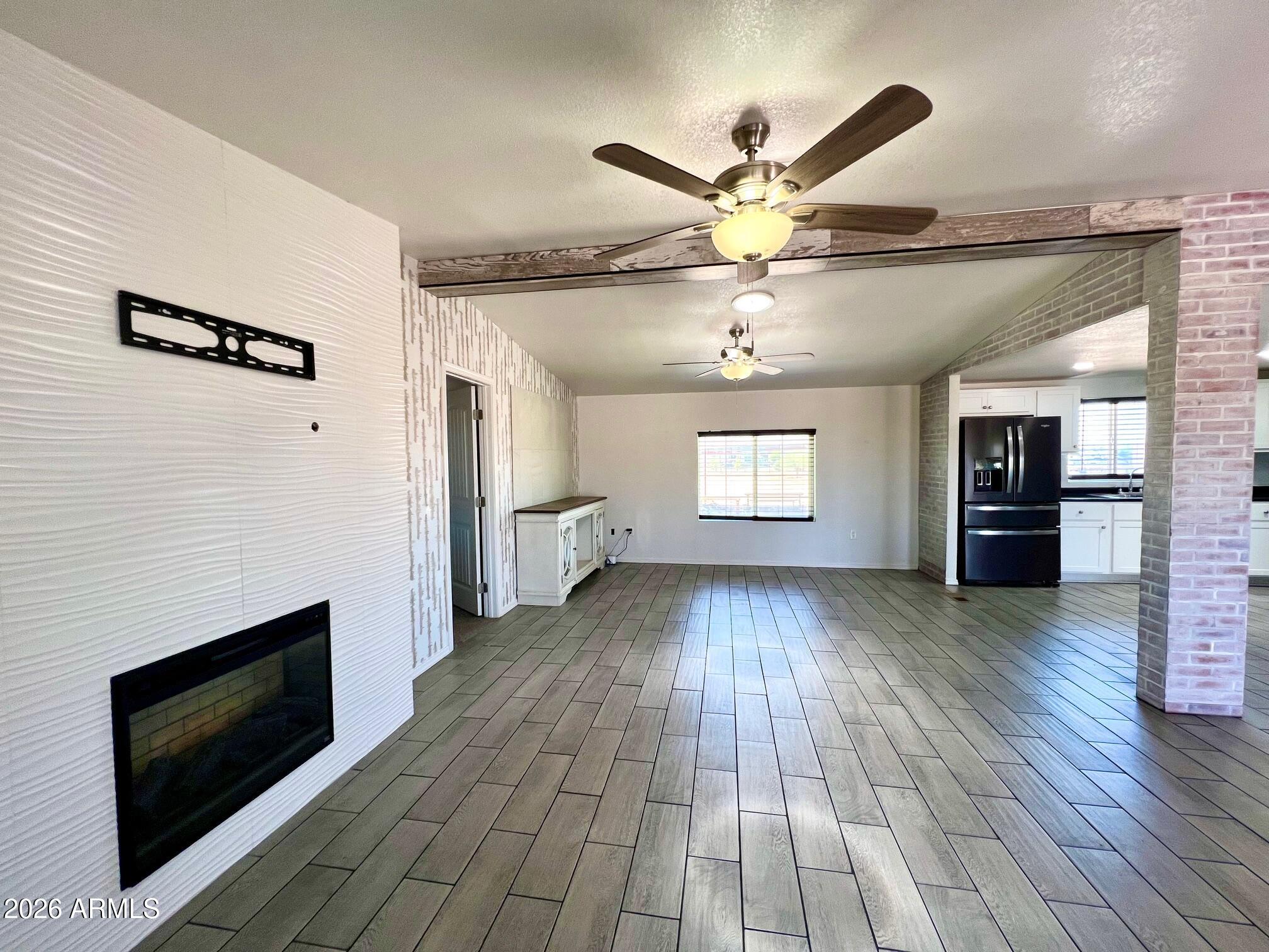 12035 East Tennyson Road Florence, AZ 85132 - Photo 11 of 42 a view of livingroom with hardwood floor and a ceiling fan