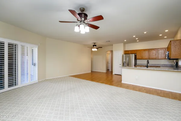 a view of a kitchen with a sink and a ceiling fan
