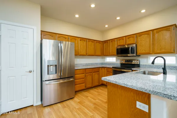 a kitchen with granite countertop a refrigerator and a sink
