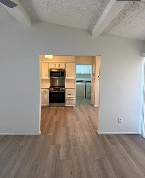 5232 95th Street Lubbock, TX 79424 - Photo 20 of 35 a view of a kitchen with wooden floor and electronic appliances